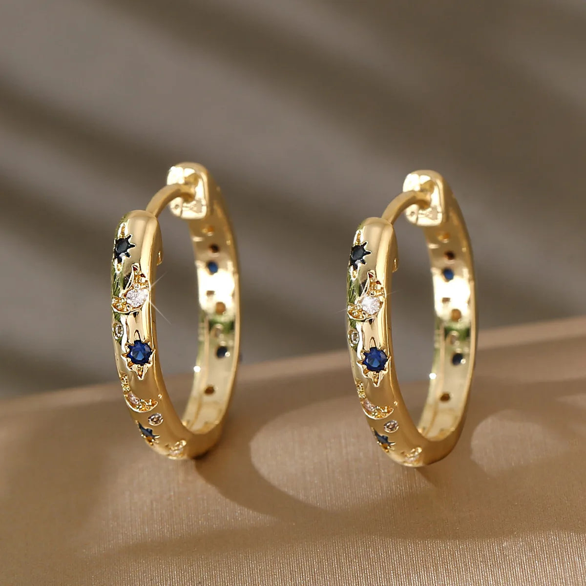 Gold Tone Copper Alloy Hoop Earrings with Blue Zircons