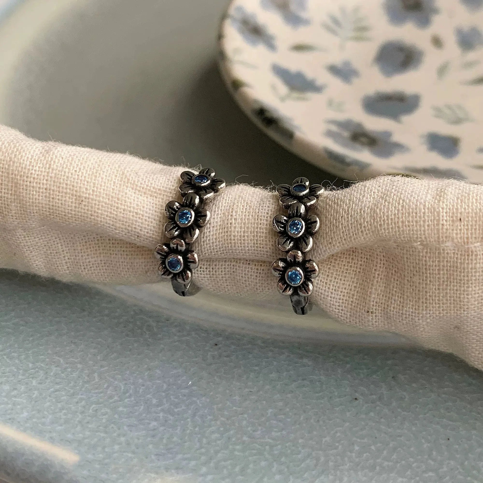 Blackened 925 Sterling Silver Blue CZ Flower Hoop Earrings